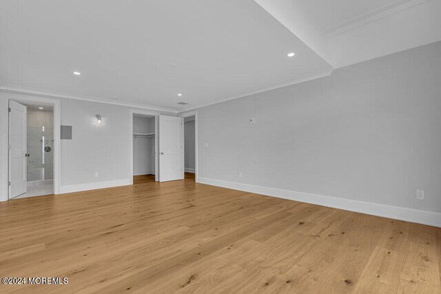 interior space featuring light wood-type flooring and crown molding