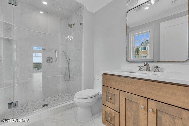 bathroom featuring vanity, toilet, and a shower with shower door