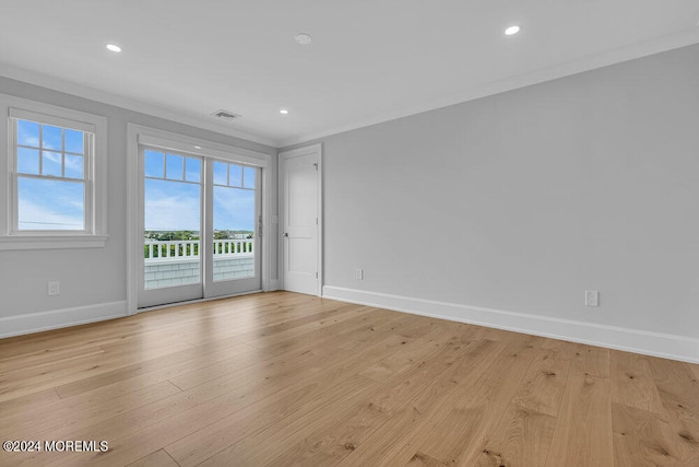 spare room featuring light hardwood / wood-style floors and ornamental molding