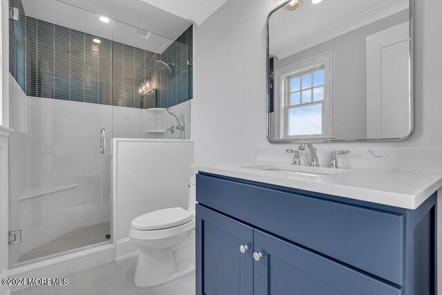 bathroom featuring tile patterned floors, an enclosed shower, vanity, and toilet