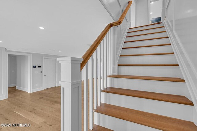 staircase featuring wood-type flooring