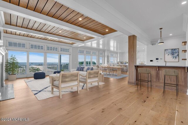 living room featuring light hardwood / wood-style flooring, beam ceiling, and wooden ceiling