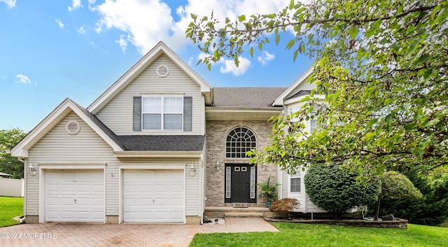 front facade with a front yard and a garage