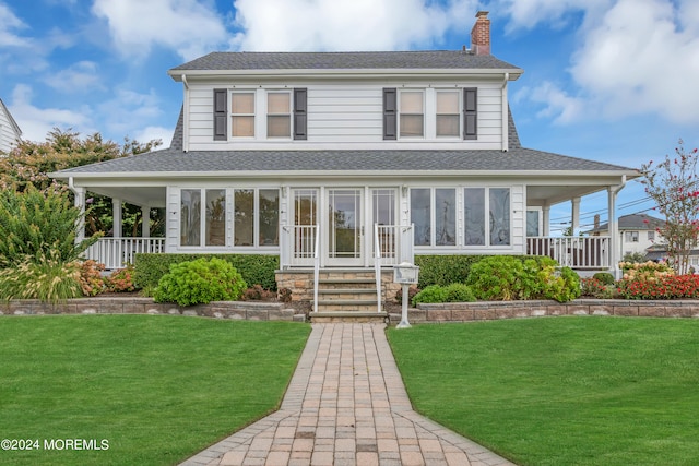 farmhouse featuring a porch and a front lawn