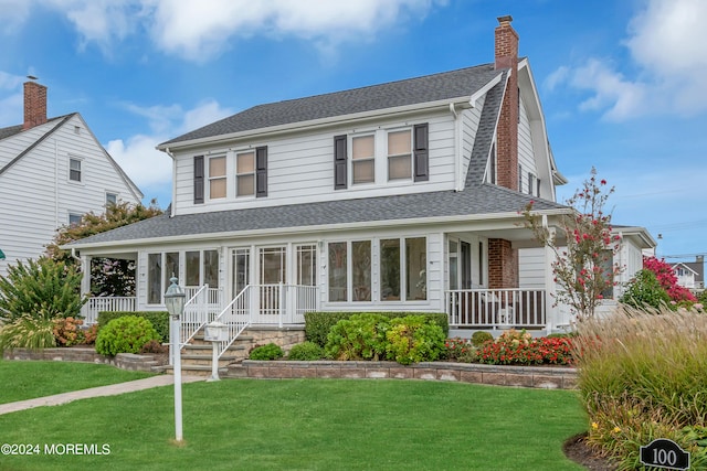 view of front facade featuring a front lawn and a porch