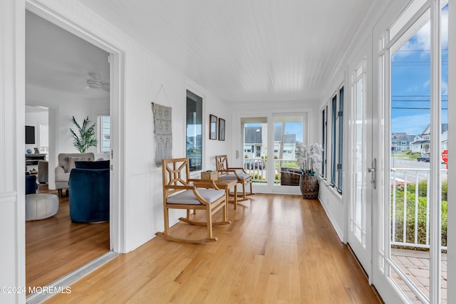 sunroom / solarium with ceiling fan and french doors