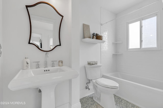 full bathroom with toilet, tiled shower / bath combo, and sink