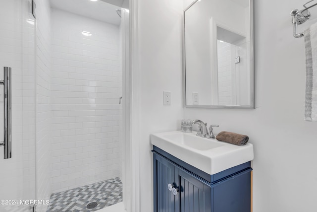 bathroom with a shower with door and vanity