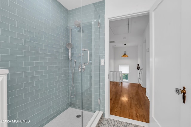 bathroom featuring wood-type flooring and walk in shower