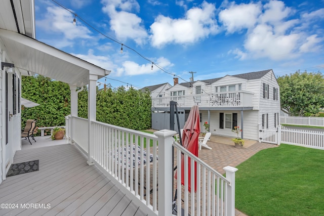 deck with a lawn and a patio