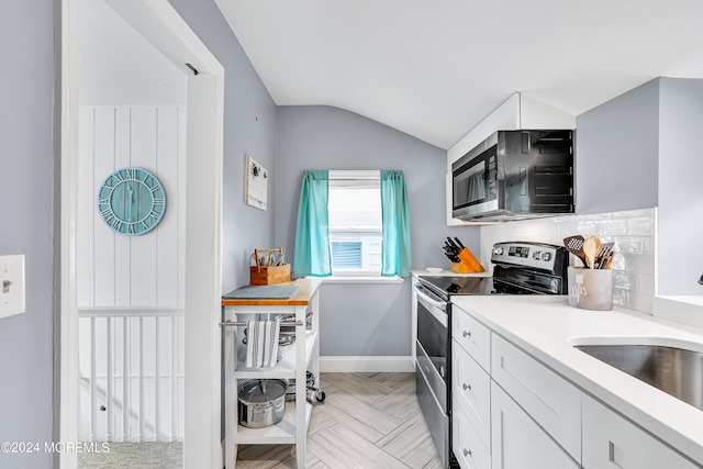 kitchen featuring white cabinetry, lofted ceiling, electric stove, light parquet flooring, and decorative backsplash