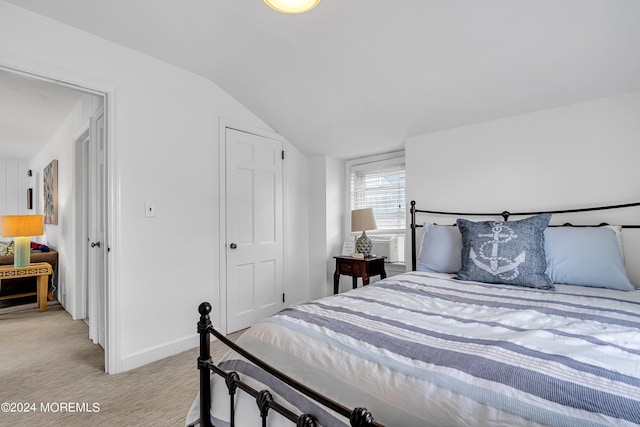 carpeted bedroom featuring vaulted ceiling