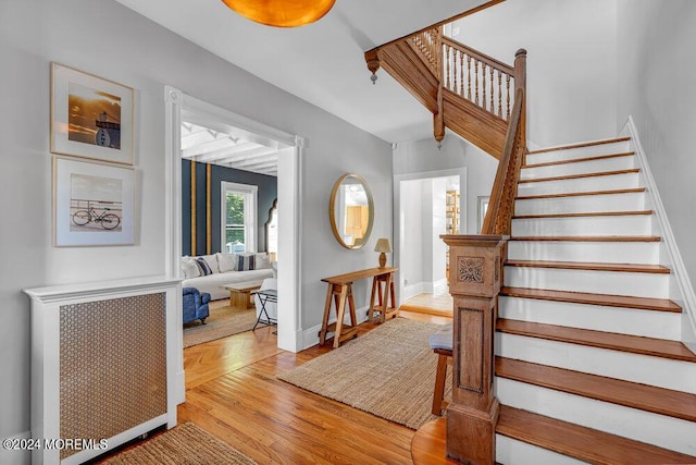 stairway featuring wood finished floors and baseboards