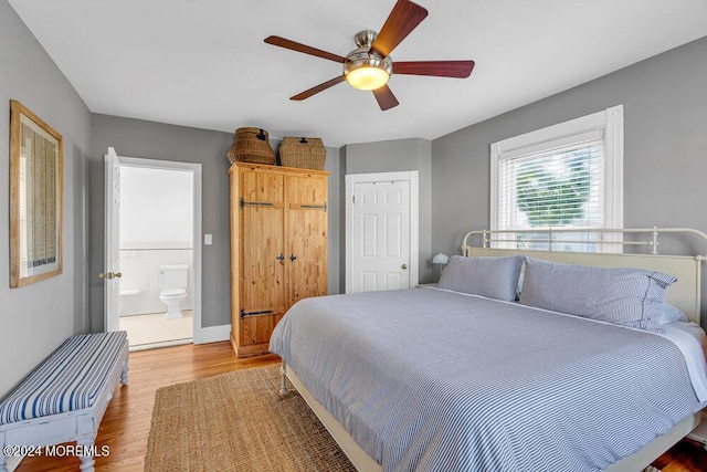 bedroom featuring a closet, ceiling fan, baseboards, and wood finished floors