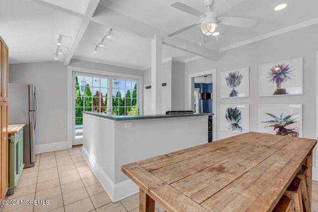 dining space featuring light tile patterned floors, ceiling fan, baseboards, and ornamental molding