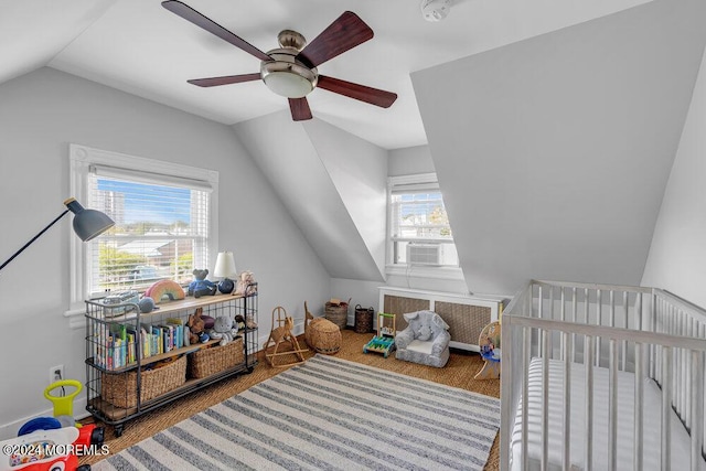 interior space featuring a nursery area, multiple windows, lofted ceiling, and wood finished floors