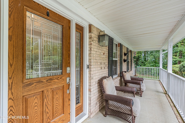 view of exterior entry with covered porch