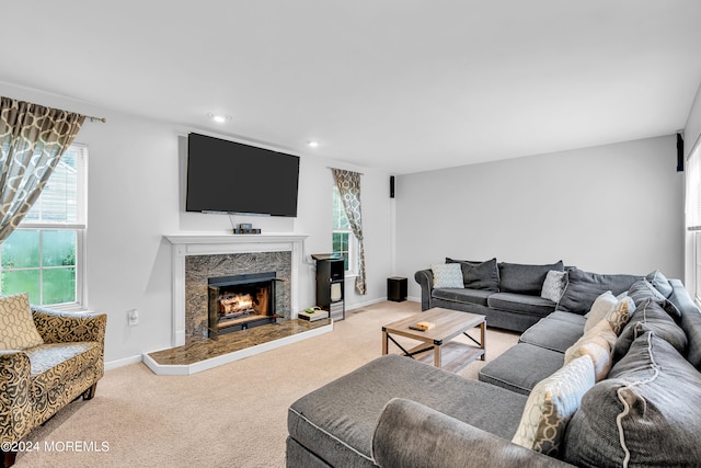 living room with light colored carpet and a fireplace