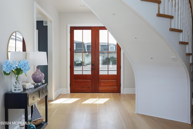 entryway featuring french doors and light hardwood / wood-style flooring