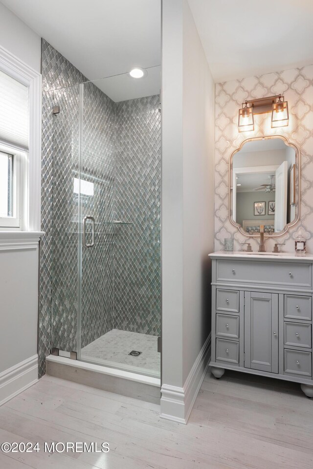 bathroom featuring vanity, hardwood / wood-style flooring, and an enclosed shower