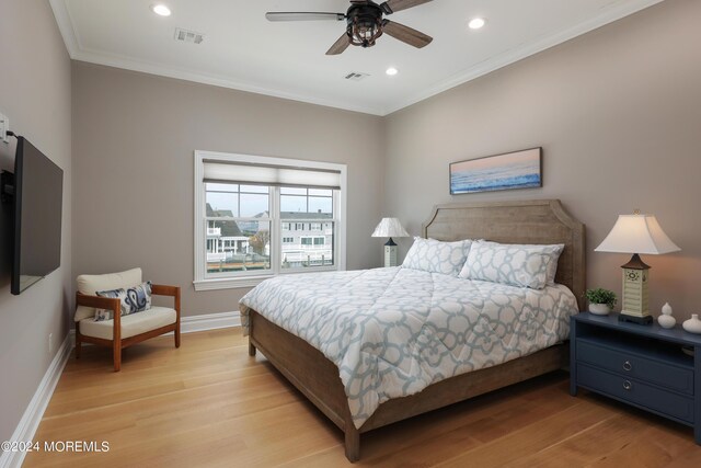 bedroom with ceiling fan, ornamental molding, and light wood-type flooring