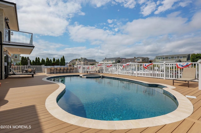 view of swimming pool featuring a deck