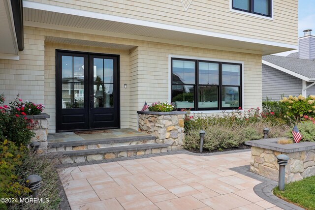 doorway to property featuring a patio area and french doors