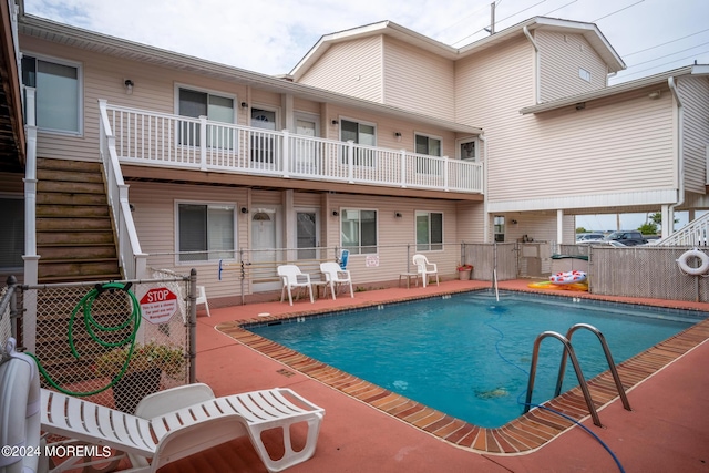 community pool featuring a patio area and fence