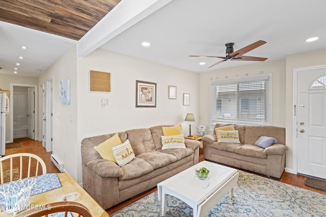 living area featuring a baseboard heating unit, ceiling fan, beam ceiling, recessed lighting, and wood finished floors