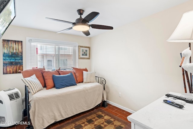 bedroom with a ceiling fan and baseboards