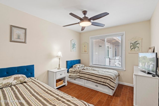 bedroom with wood finished floors, baseboards, and ceiling fan