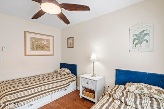 bedroom featuring a ceiling fan, wood finished floors, and baseboards