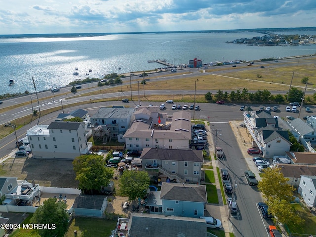 drone / aerial view featuring a residential view and a water view