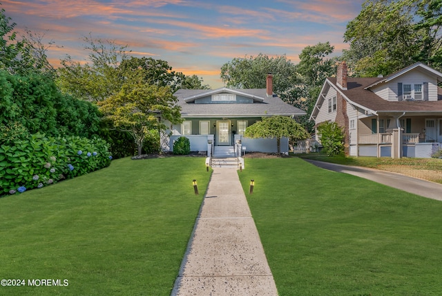 bungalow with a lawn and a porch