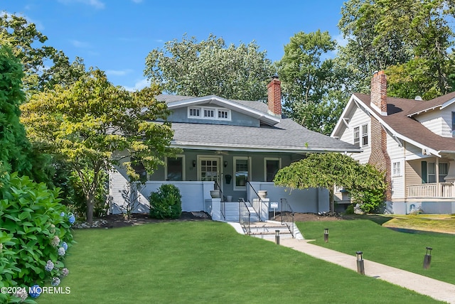 view of front of home with a porch and a front lawn