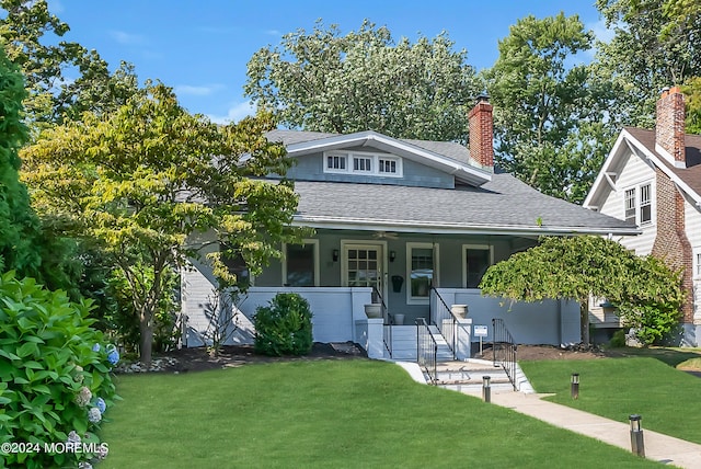 bungalow-style house with a porch and a front yard