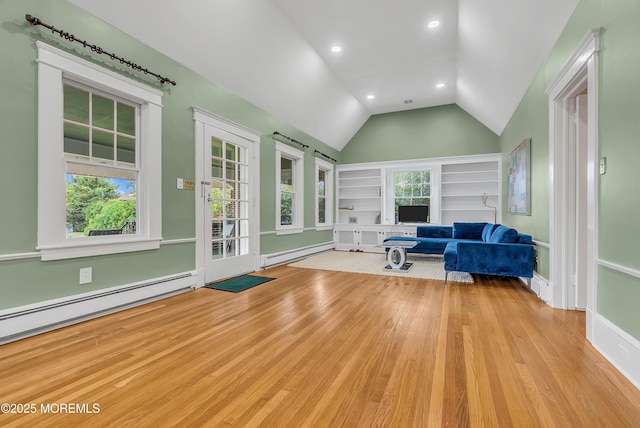 sitting room with light wood-type flooring, a baseboard radiator, and lofted ceiling