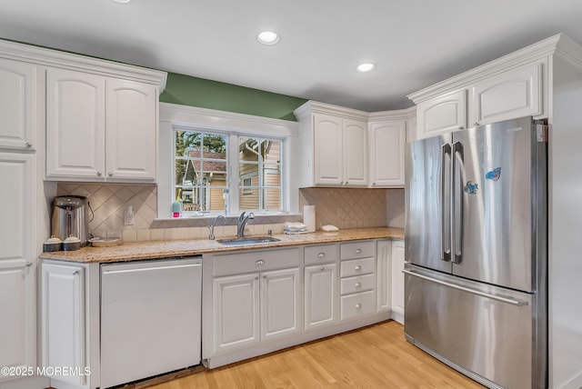 kitchen featuring sink, white cabinetry, and stainless steel appliances