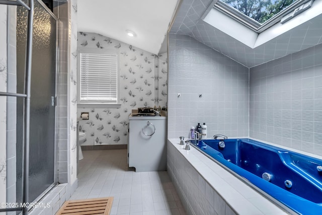 bathroom with tile patterned flooring, separate shower and tub, lofted ceiling with skylight, and toilet