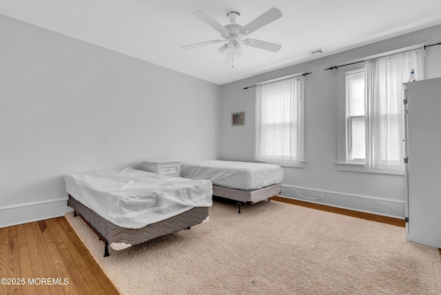 bedroom with ceiling fan and hardwood / wood-style flooring