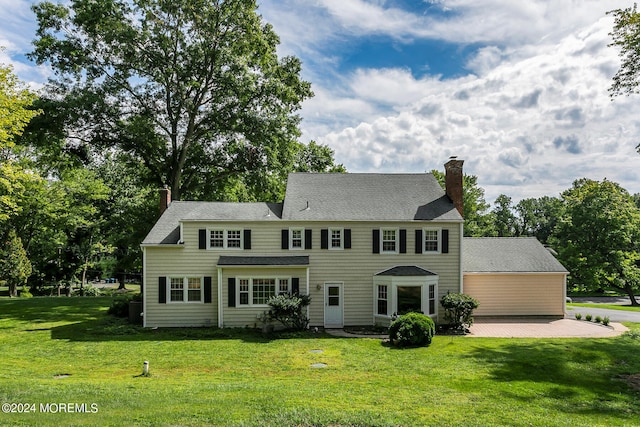 colonial-style house with a front yard