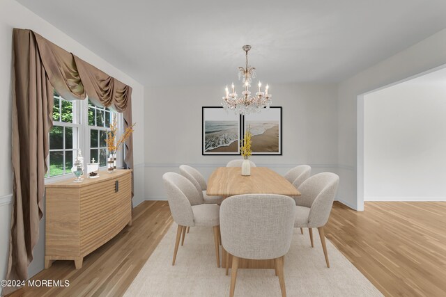 dining area with an inviting chandelier and light hardwood / wood-style floors