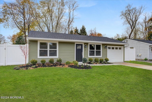 view of front of property with a garage and a front yard