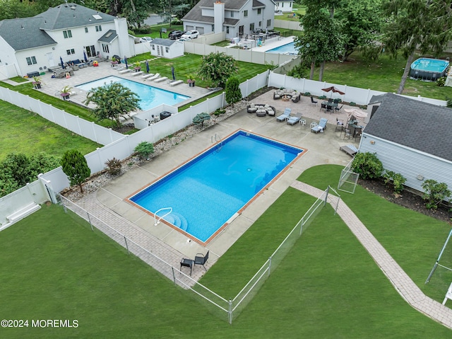 pool with a lawn, a patio area, and a fenced backyard