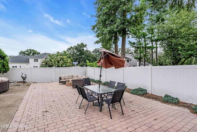 view of patio / terrace with outdoor dining space, a fenced backyard, and an outdoor living space