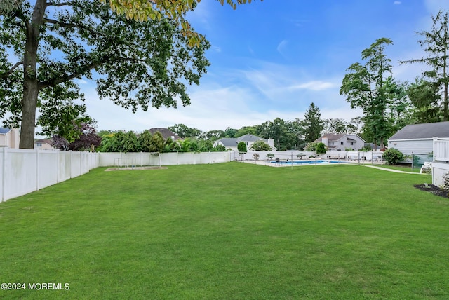 view of yard with a fenced in pool and a fenced backyard