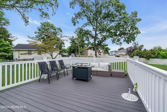 wooden terrace with a lawn, outdoor lounge area, and fence