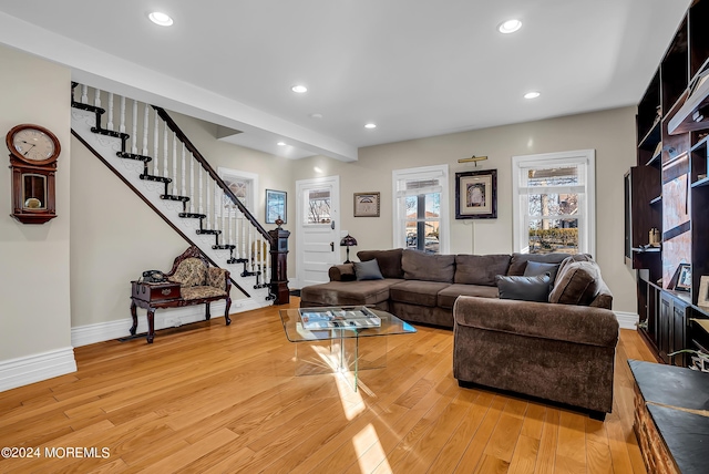 living room with stairs, recessed lighting, baseboards, and light wood-style floors