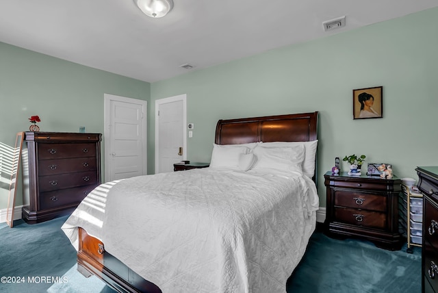 bedroom with baseboards, visible vents, and carpet flooring