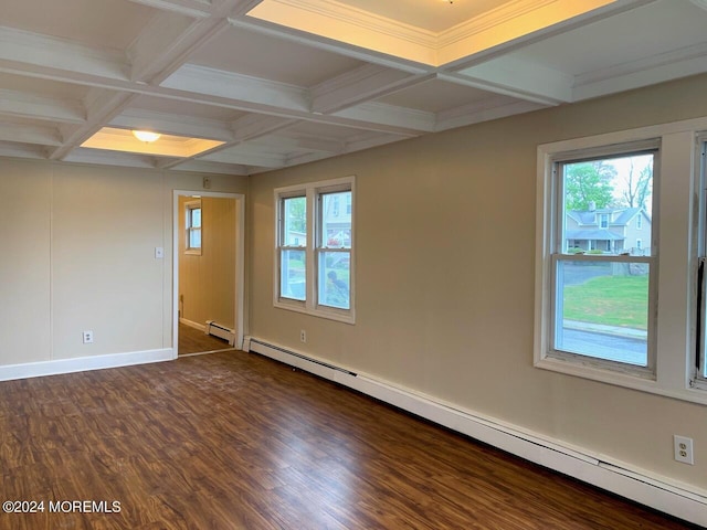 empty room featuring a wealth of natural light, baseboard heating, and dark wood-style flooring